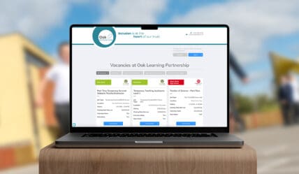 The image shows a laptop with a visual of a vacancies portal website showing multiple vacancies for a trust.