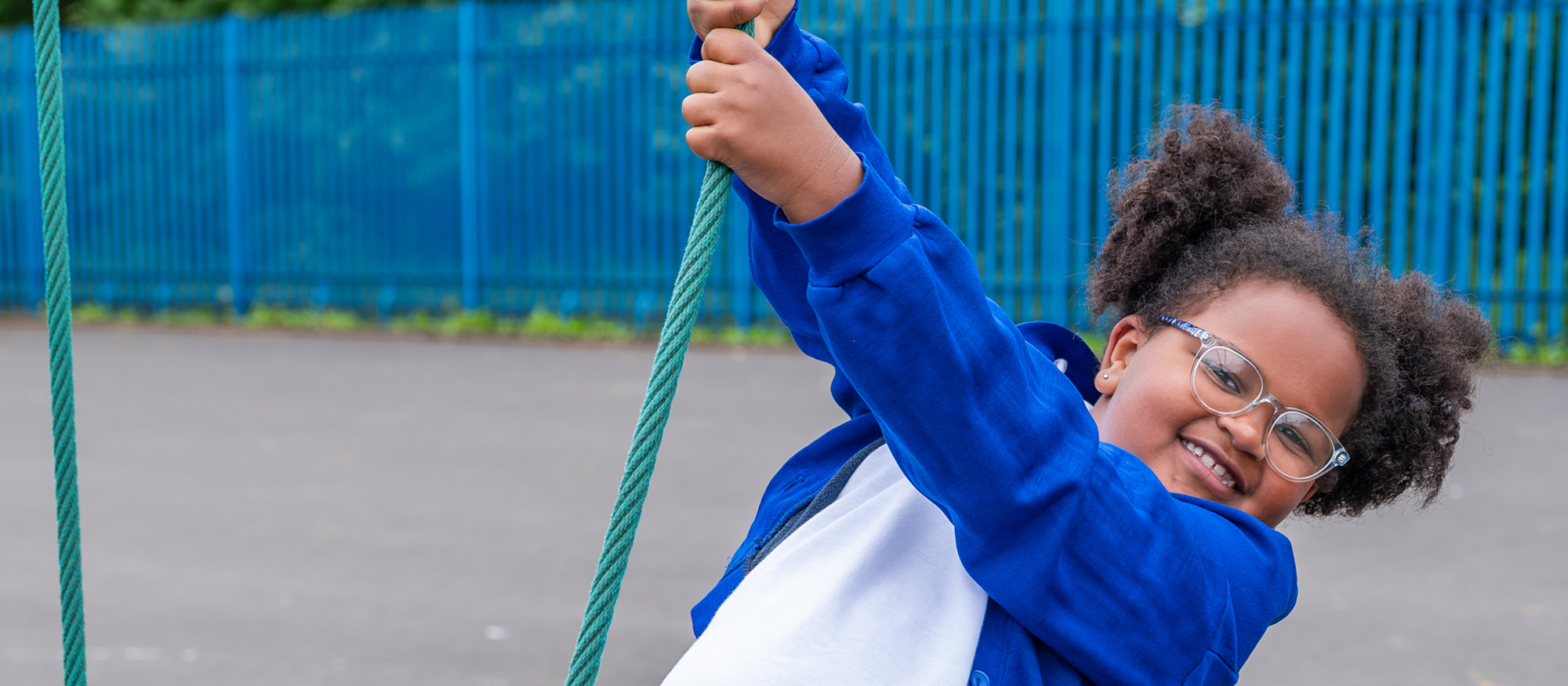 Summerville primary school photography - student swinging on play equipment