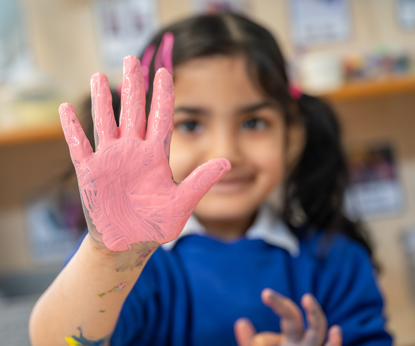 Summerville primary school photography - student showing hand covered in paint during art class
