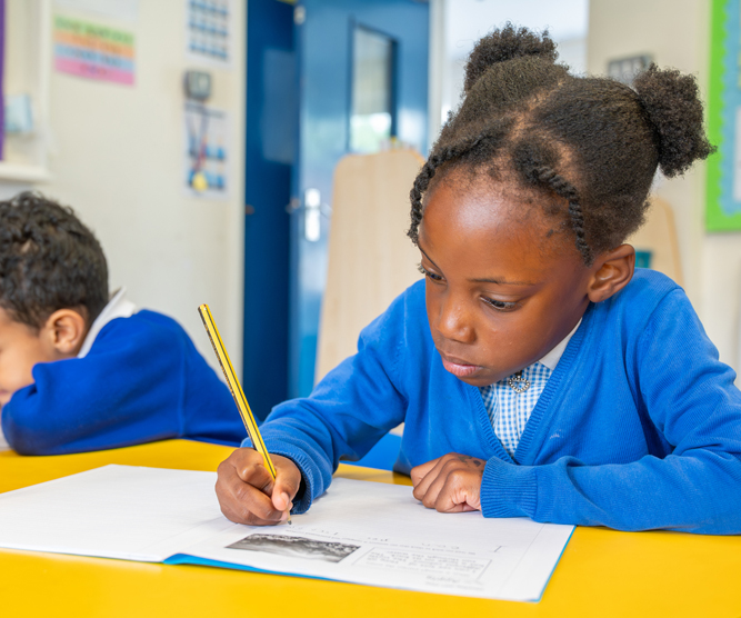 Summerville primary school photography - student in class doing writing