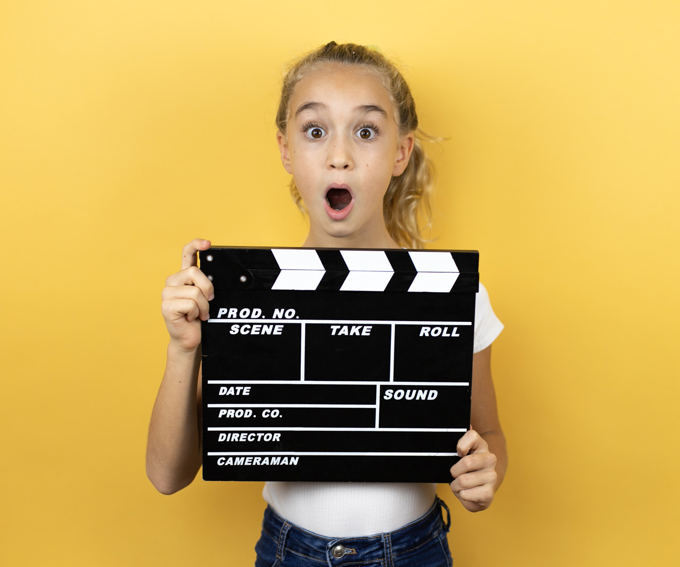 Whats included in our film production services - student holding a film clapper board 