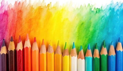 Blog post - creating a consistent school trust identity. Image of lined up colouring pencils.
