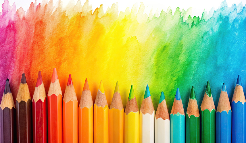 Blog post - creating a consistent school trust identity. Image of lined up colouring pencils.